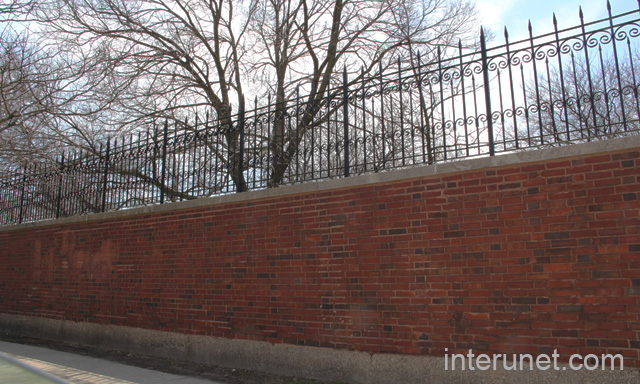 brick-wall-with-metal-fence-on-top