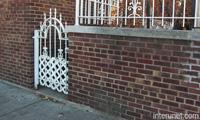 brick-fence-with-white-metal-gate
