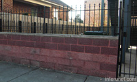 metal-fence-over-red-concrete-blocks