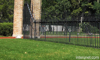 metal-fence-with-brick-columns-gate