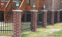metal-fence-with-lights-on-brick-pillars