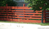 wood-fence-with-horizontal-boards-painted-red