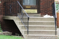 concrete-stairs-and-porch-with-metal-railing