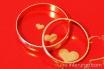 wedding-rings-on-red-background-with-hearts