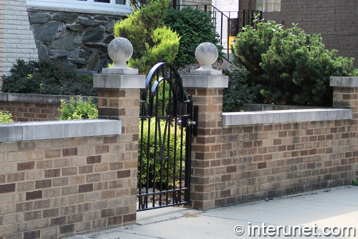 brick fence with metal gate