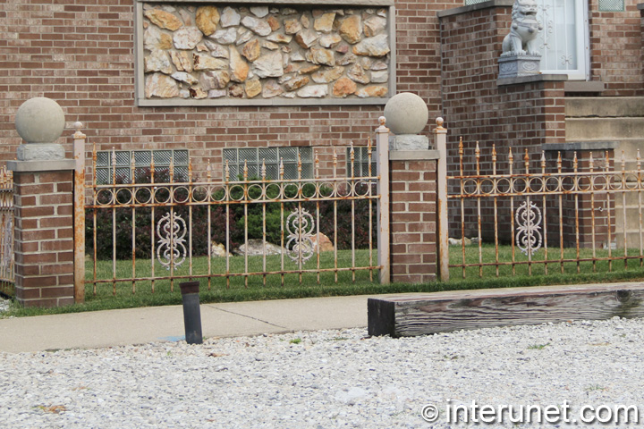 stylish-metal-fence-with-brick-pillars