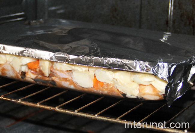 baking-tray-covered-with-aluminum-foil-placed-into-the-oven