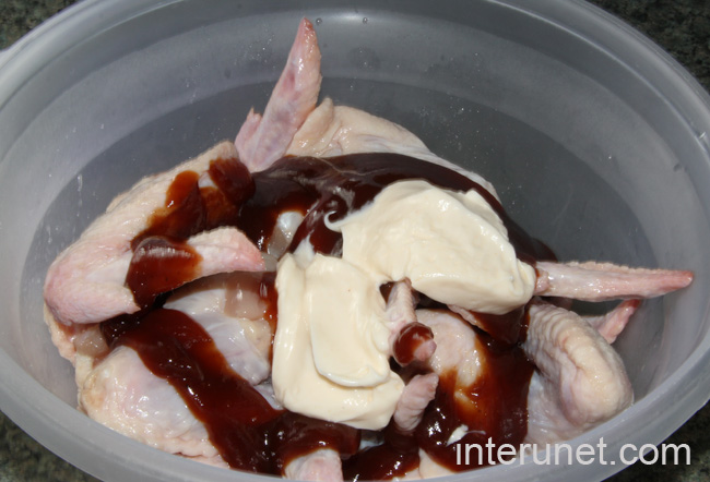 mixing-chicken-wings-with-barbecue-sauce-and-mayonnaise