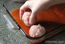 placing-meatballs-into-glass-tray