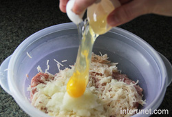 putting-egg-into-plastic-mixing-bowl
